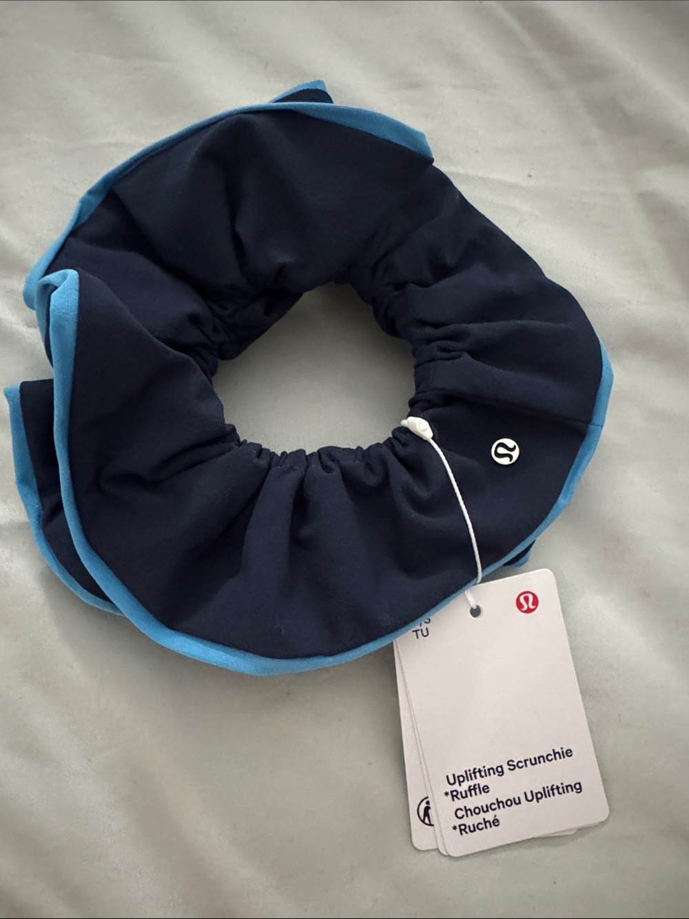lululemon navy scrunchie with sky blue trim